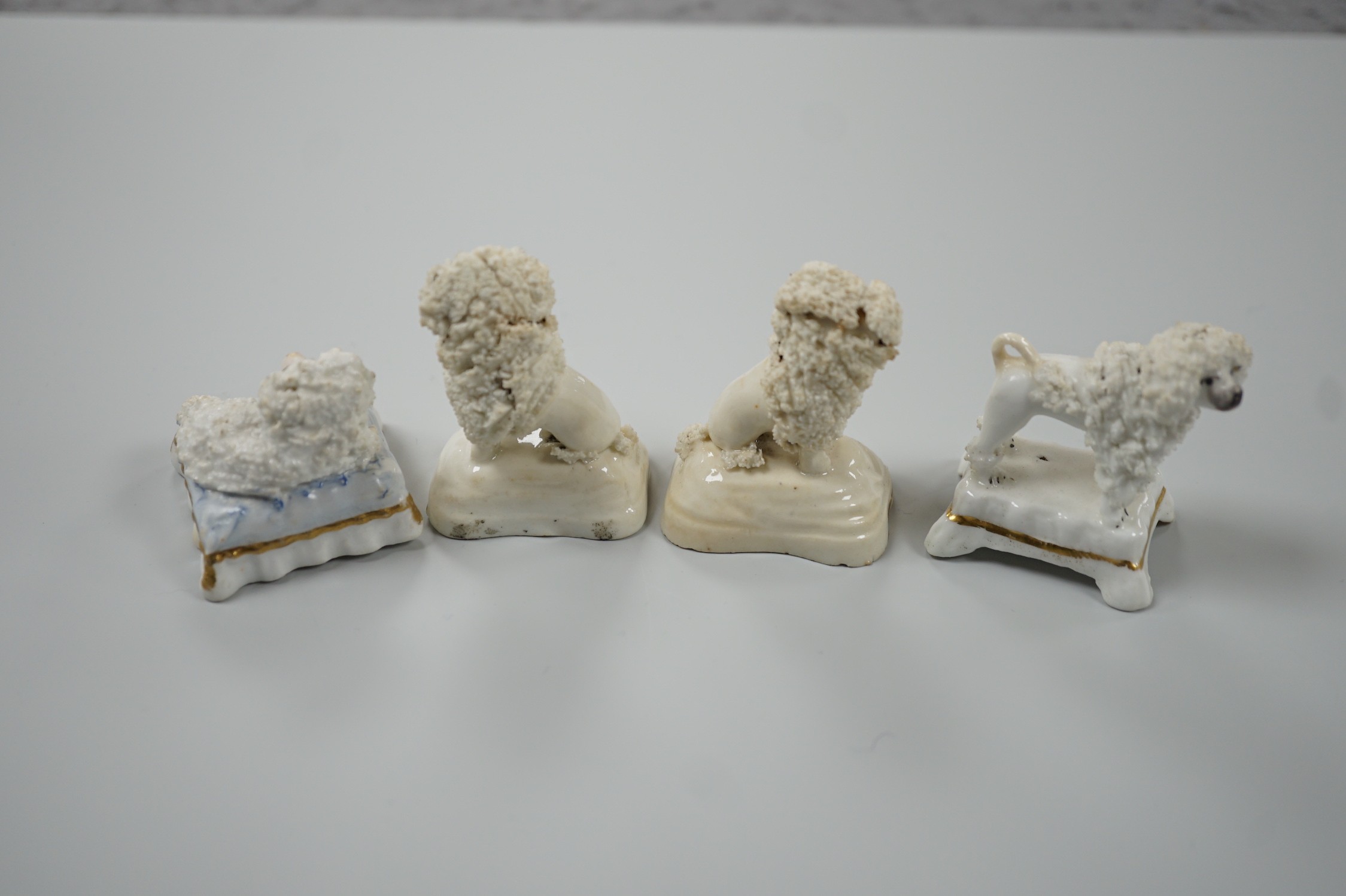 Four toy Staffordshire models of poodles, to include a pair, c.1830-50, (4). Tallest 5cm, Provence: Dennis G. Rice collection, Cf. Dennis G.Rice Dogs in English porcelain, colour plate 113